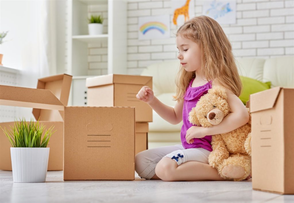 Little girl looking through box