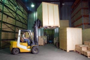 Forklift lifting a box