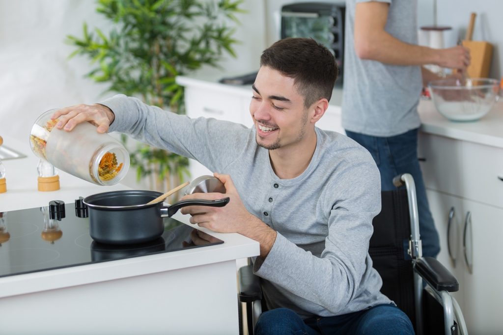 disabled young man in wheelchair in the kitchen