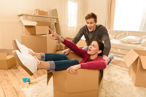 happy man and woman having fun at new home