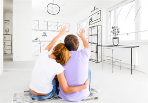 young couple looking at floor plans
