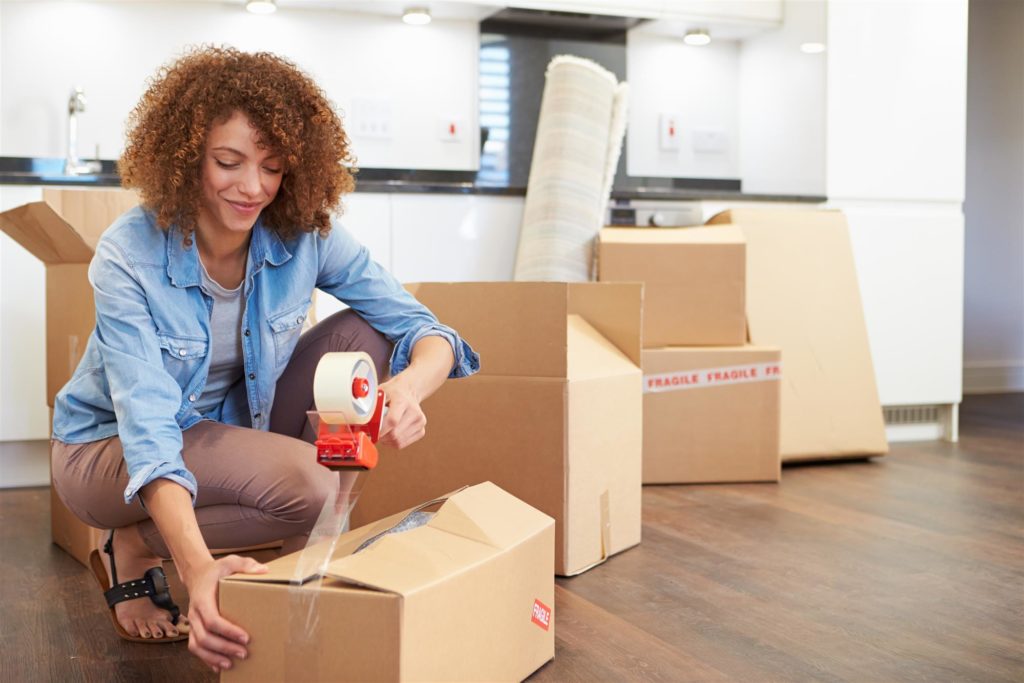 A women carry the boxes to a different area of the home