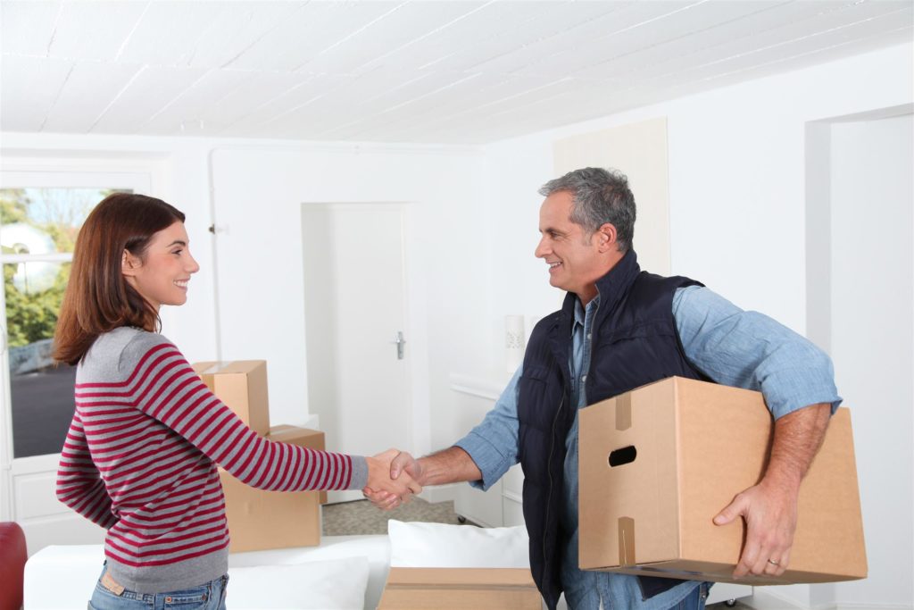 woman is shaking hand to residential moving company attendant