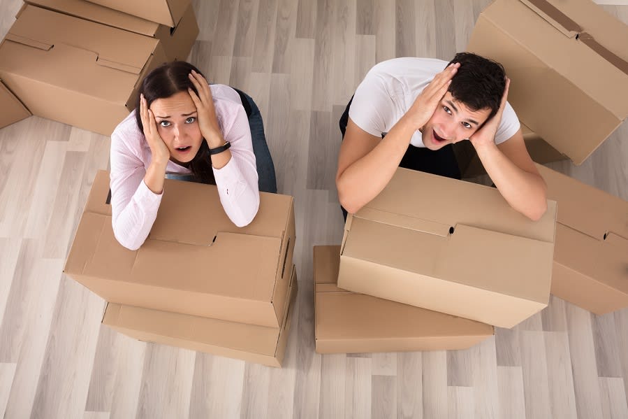 Couple Screaming Behind The Cardboard Boxes