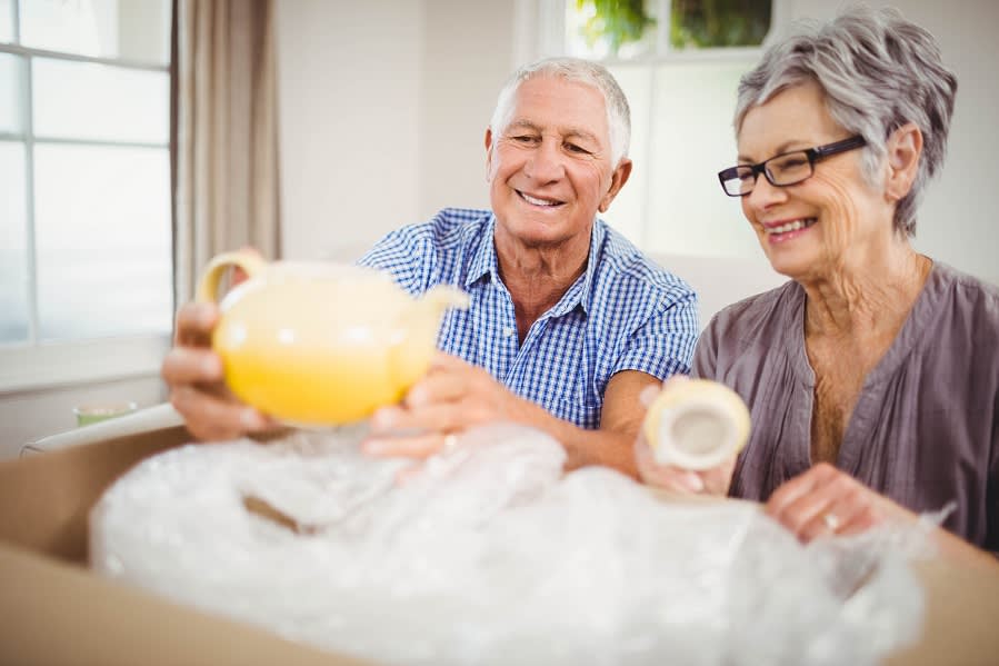 Senior Couple Unpacking a Cardboard Box in Chicago