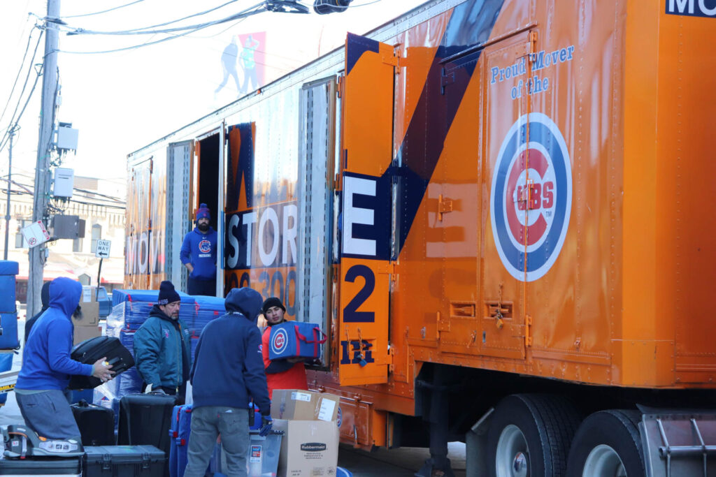Workers load a Midway shipping truck