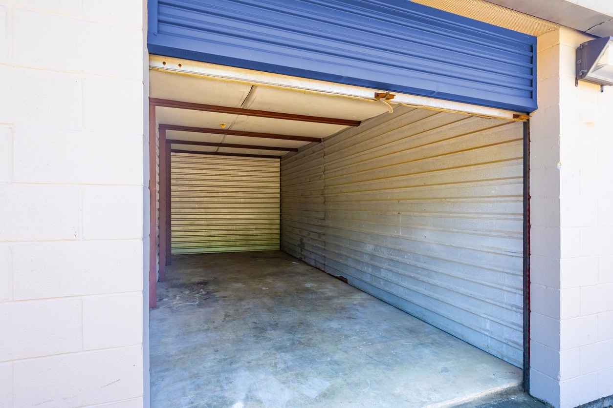 Empty storage unit with a raised blue roll-up door